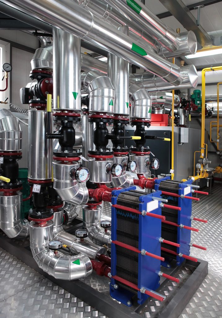 Interior of independent modern gas boiler room with manometers, valves, pumps and thermo-insulation on pipelines